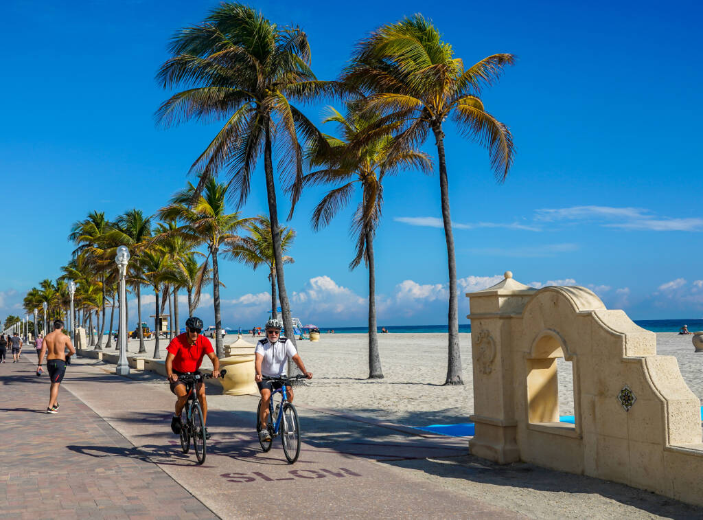 HOLLYWOOD BEACH, FLORIDA - JANUARY 29, 2020: Bicycle rider at the Hollywood Beach Broadwalk in South Florida