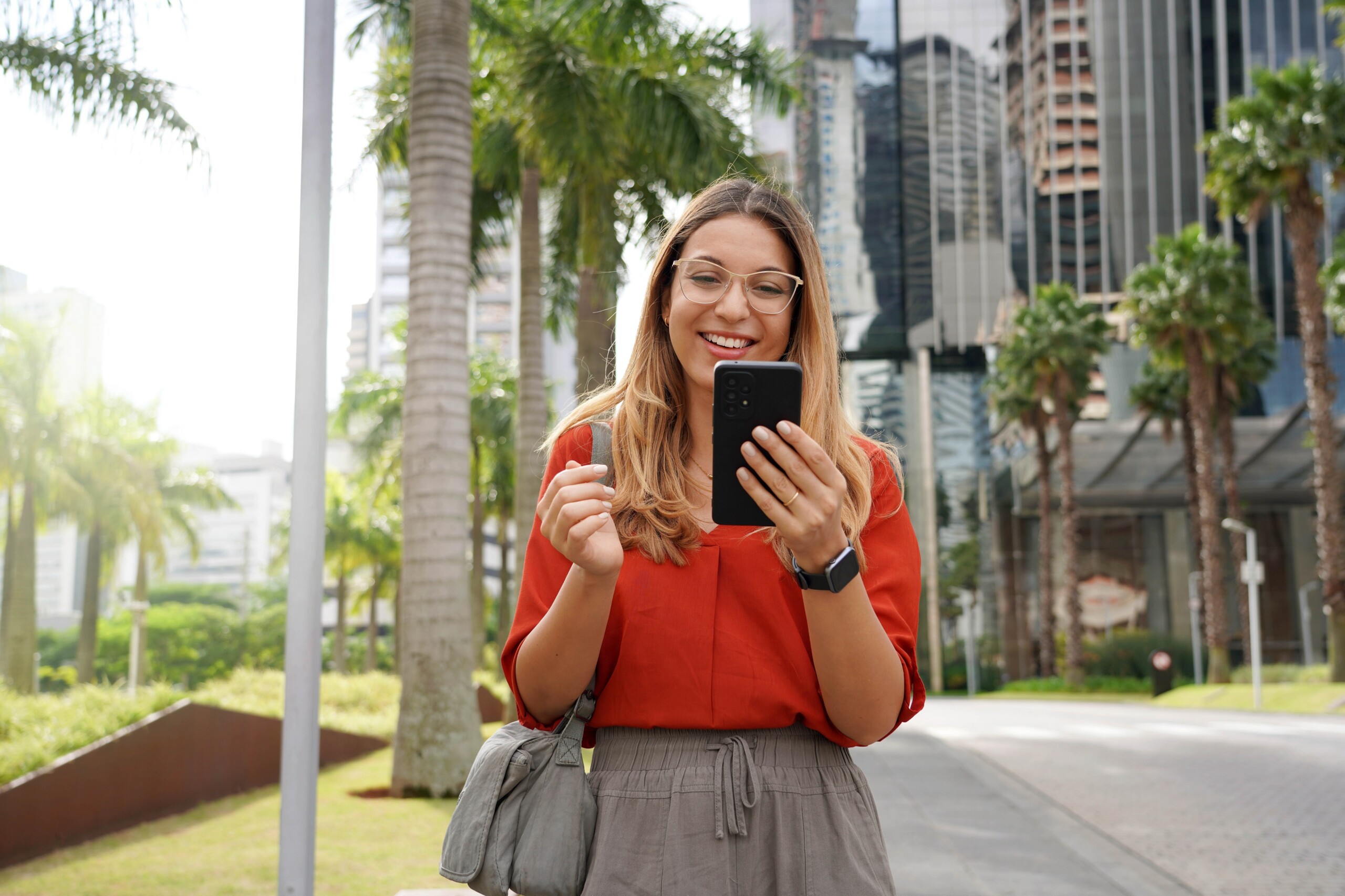 Młoda kobieta korzysta z aplikacji na telefonie, Miami, Floryda, USA, licencja: shutterstock/By Zigres